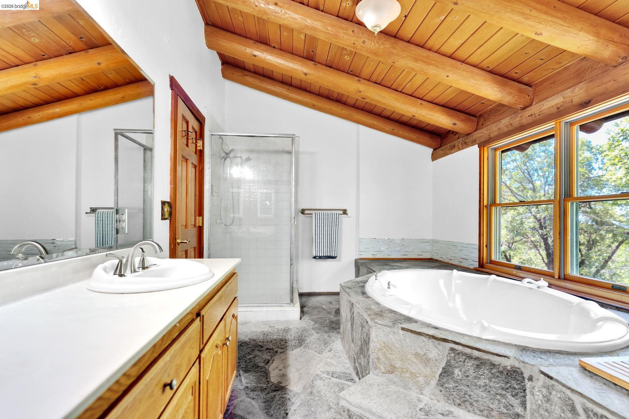 14799 Big Hill Road Sonora, CA 95370 - Photo 33 of 60 Full bathroom featuring a stall shower, vanity, wooden ceiling, a bath, and lofted ceiling with beams