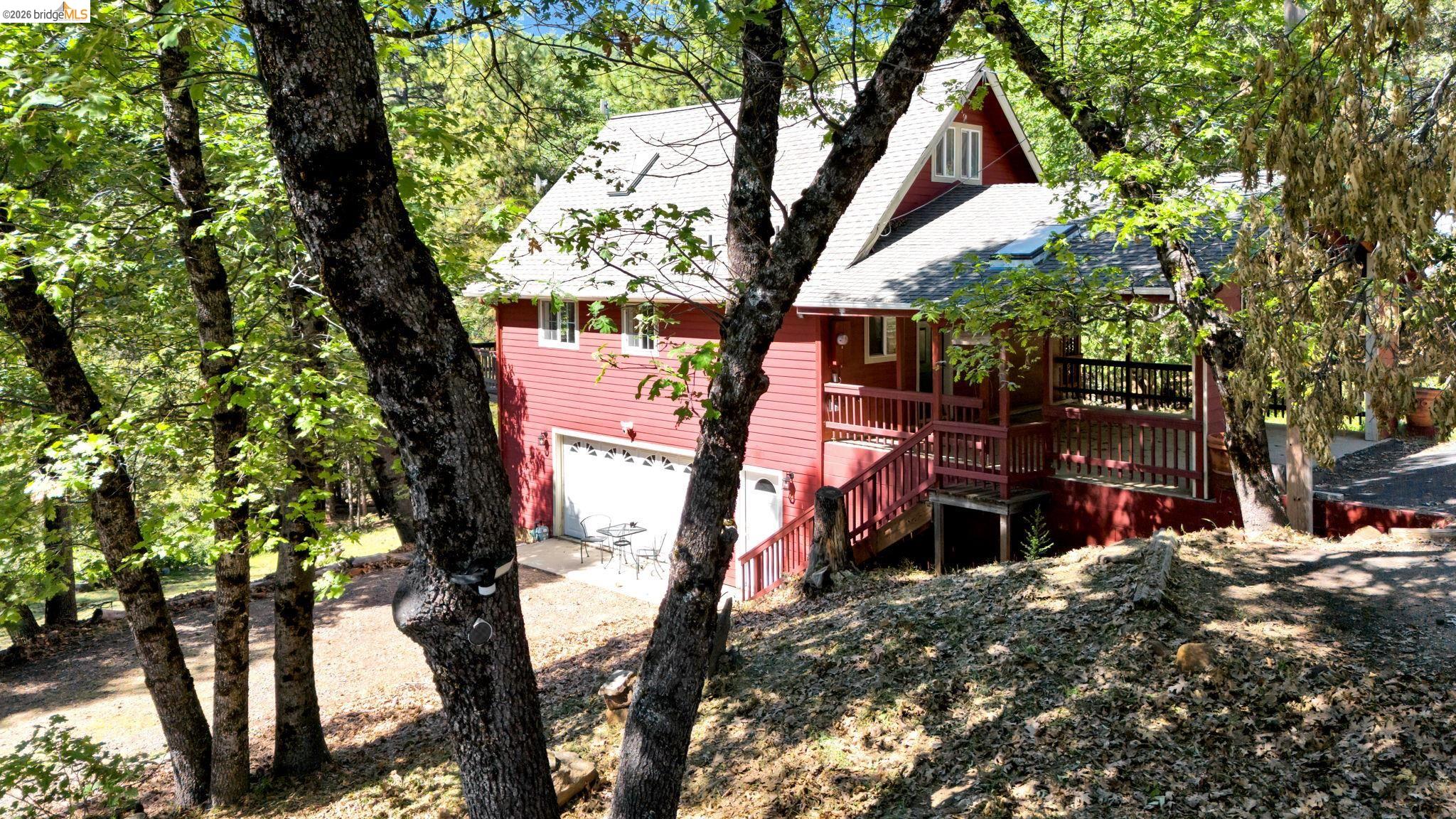 14799 Big Hill Road Sonora, CA 95370 - Photo 44 of 60 View of front of property with an attached garage, a shingled roof, and a wooden deck