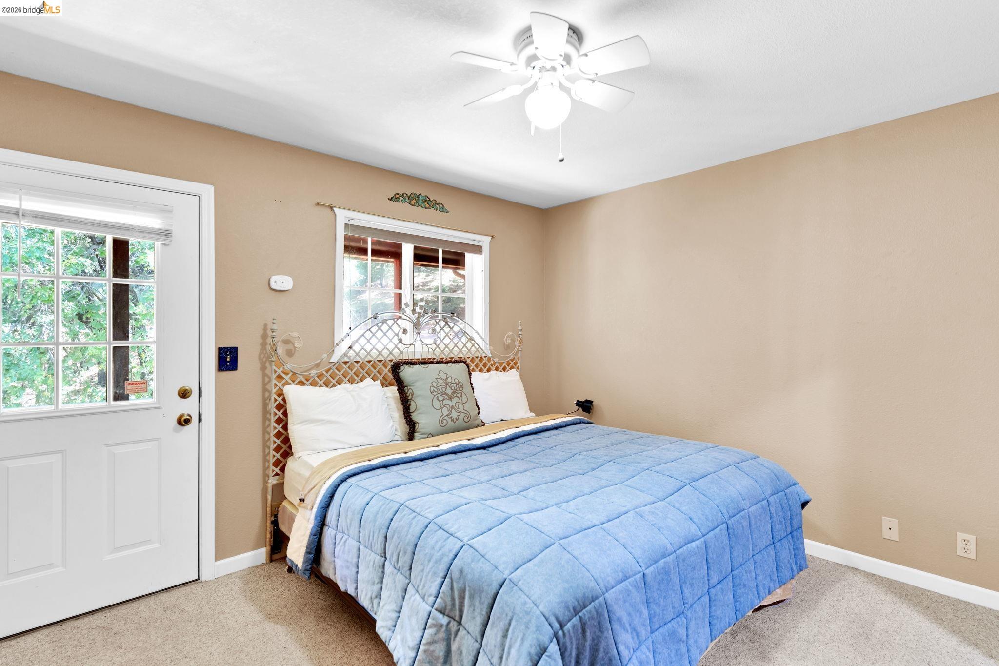 14799 Big Hill Road Sonora, CA 95370 - Photo 48 of 60 Bedroom featuring ceiling fan and light colored carpet