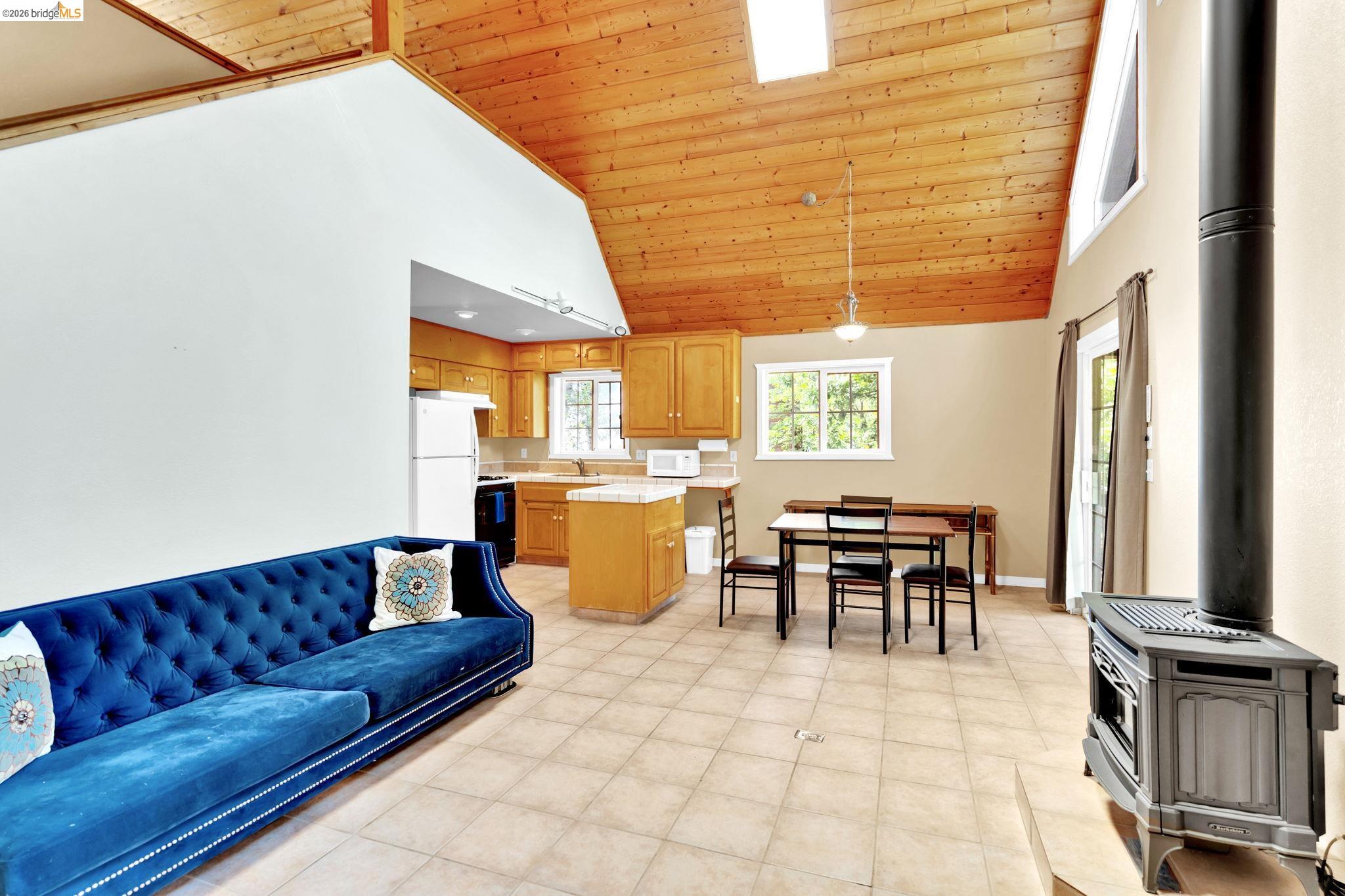 14799 Big Hill Road Sonora, CA 95370 - Photo 54 of 60 Living room with a wood stove and a vaulted wood ceiling