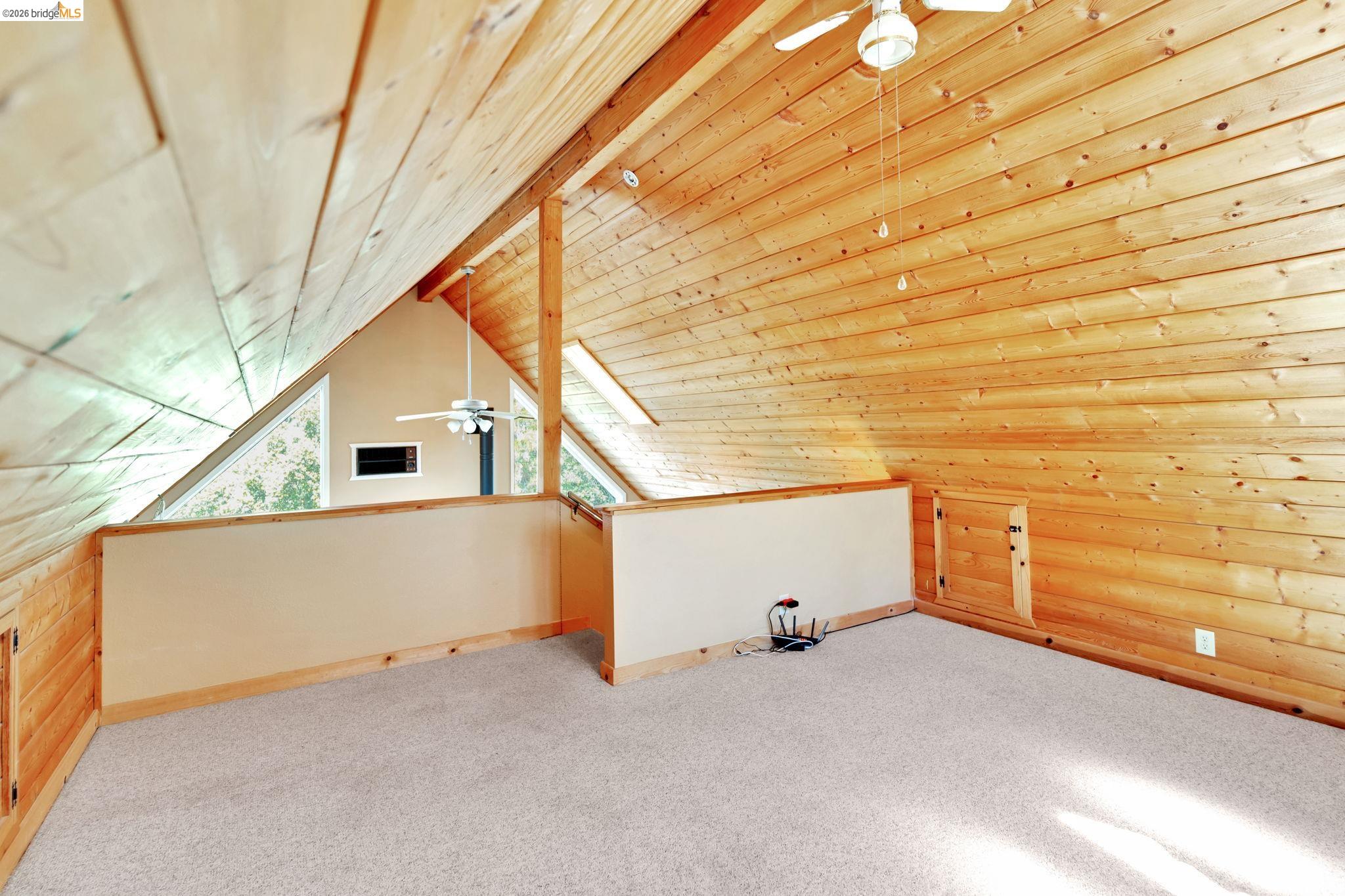 14799 Big Hill Road Sonora, CA 95370 - Photo 57 of 60 Additional living space featuring a ceiling fan, carpet floors, and a wooden ceiling with exposed beams