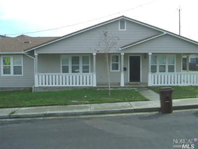 a front view of a house with a garden and porch