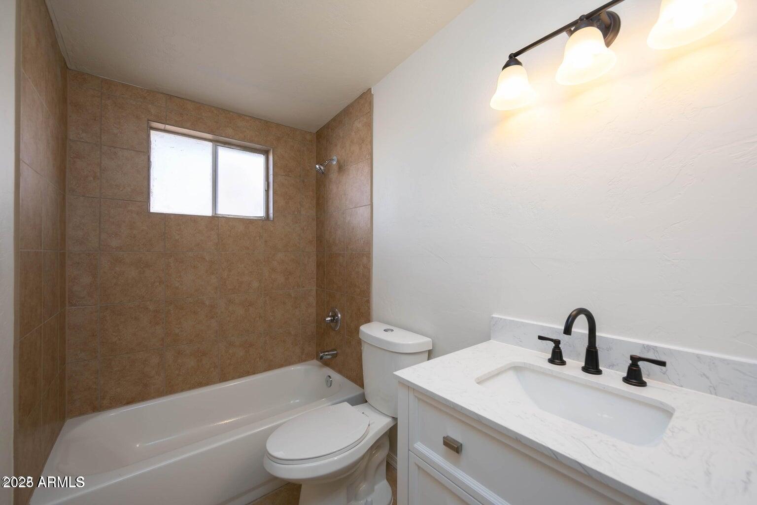 310 2nd Street Huachuca City, AZ 85616 - Photo 10 of 19 a bathroom with a toilet a sink and a bathtub