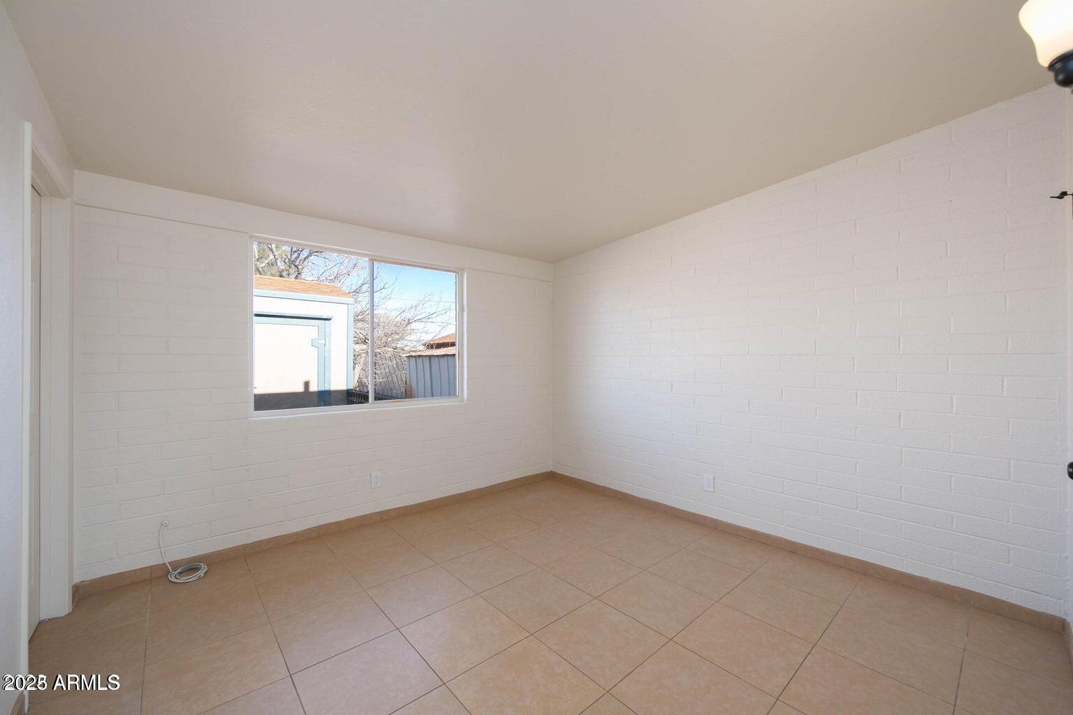 310 2nd Street Huachuca City, AZ 85616 - Photo 6 of 19 an empty room with windows