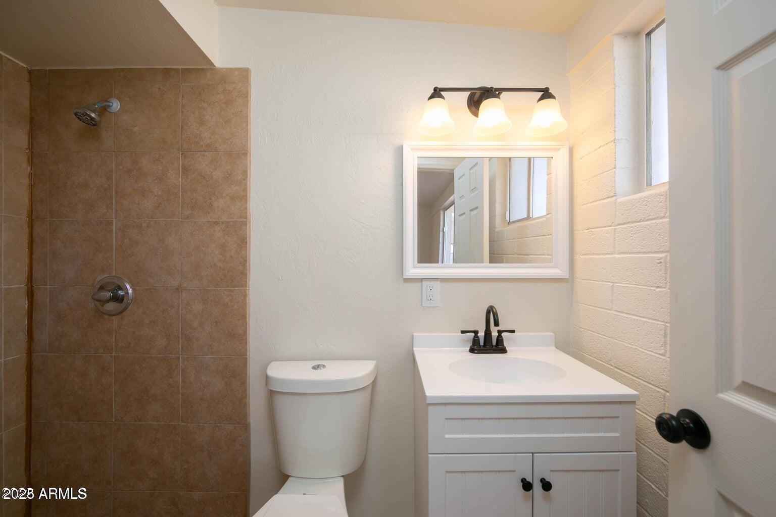 310 2nd Street Huachuca City, AZ 85616 - Photo 7 of 19 a bathroom with a sink toilet and mirror