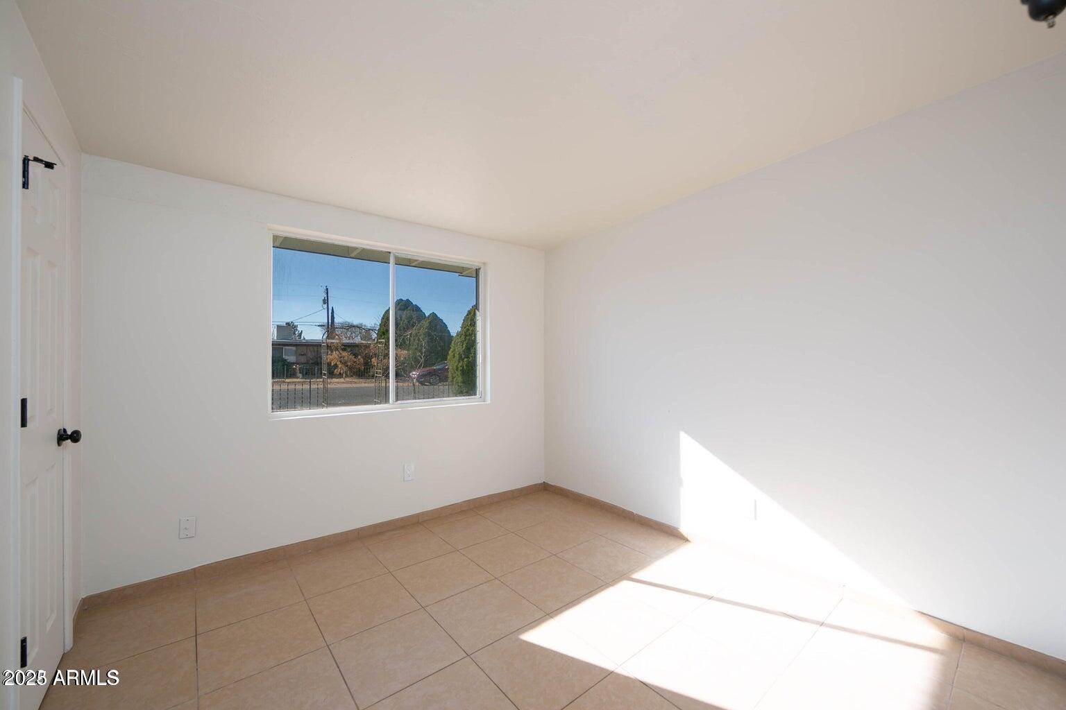 310 2nd Street Huachuca City, AZ 85616 - Photo 8 of 19 a view of an empty room with a window