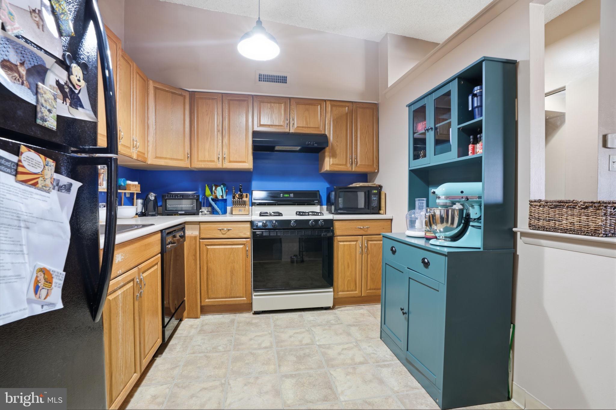 62204 Delaire Landing Road, Unit 204 Philadelphia, PA 19114 - Photo 11 of 35 a kitchen with stainless steel appliances granite countertop a stove top oven a sink and dishwasher