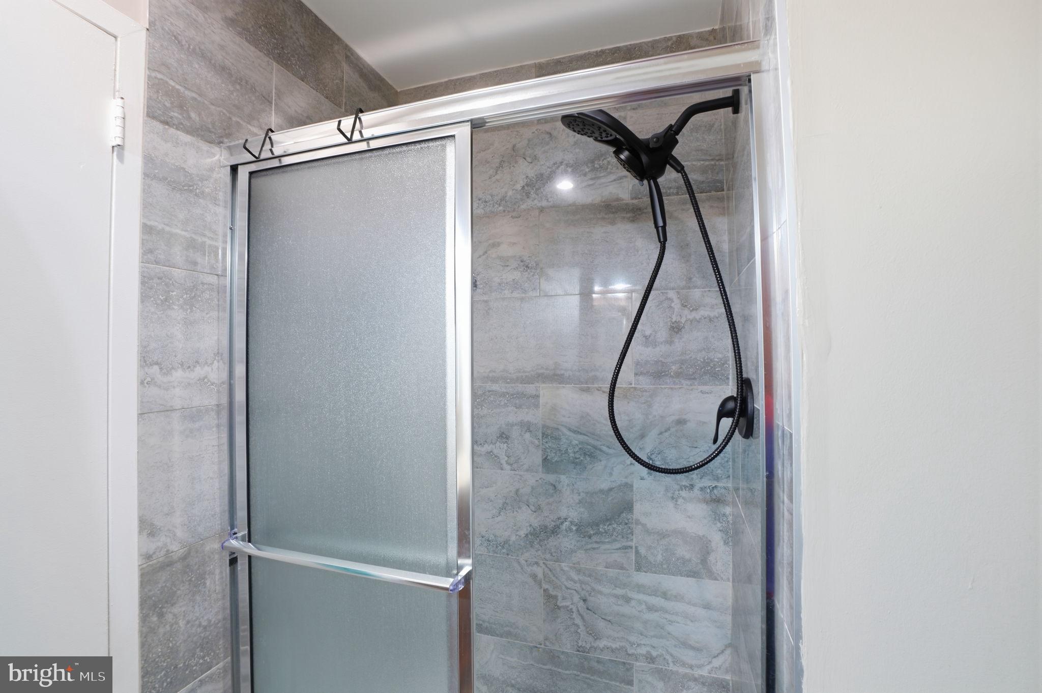 62204 Delaire Landing Road, Unit 204 Philadelphia, PA 19114 - Photo 11 of 29 a bathroom with a glass shower door