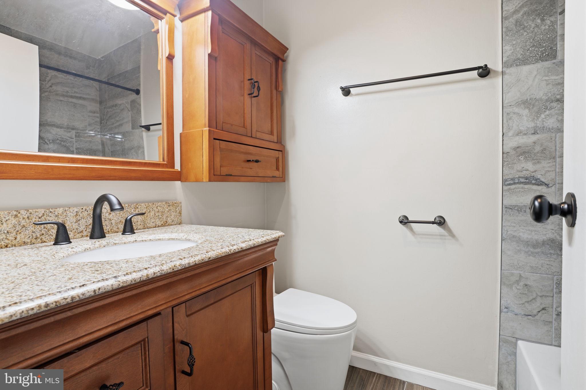 62204 Delaire Landing Road, Unit 204 Philadelphia, PA 19114 - Photo 12 of 29 a bathroom with a granite countertop sink toilet and shower