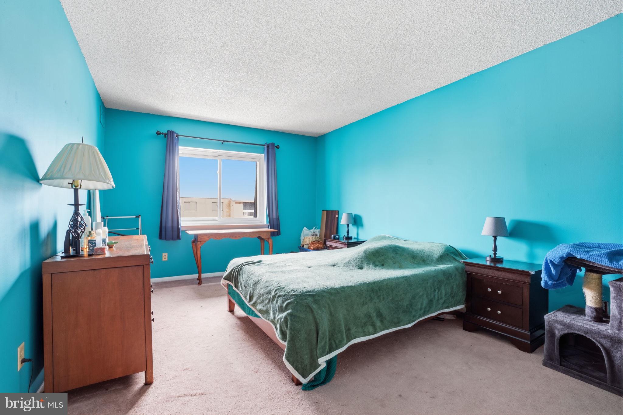 62204 Delaire Landing Road, Unit 204 Philadelphia, PA 19114 - Photo 13 of 35 a bedroom with a bed and a table in it