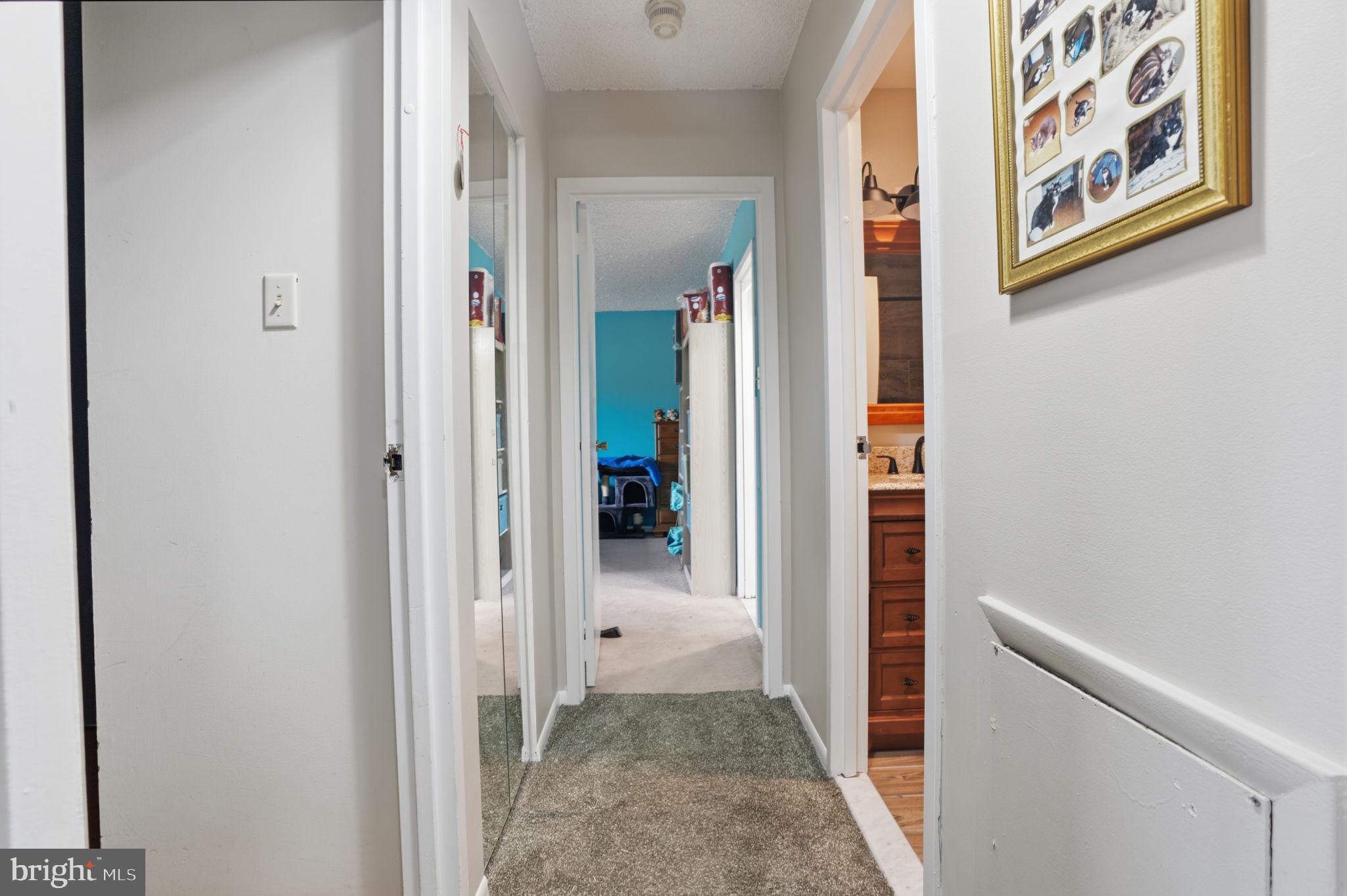 62204 Delaire Landing Road, Unit 204 Philadelphia, PA 19114 - Photo 14 of 29 a view of a hallway with paintings on the wall