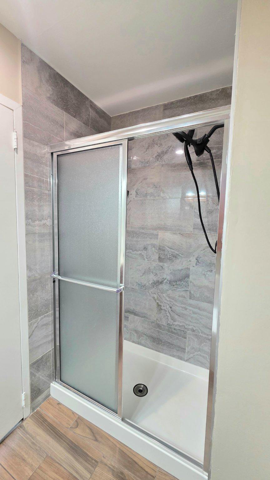 62204 Delaire Landing Road, Unit 204 Philadelphia, PA 19114 - Photo 18 of 35 Sleek modern shower with elegant tiles.