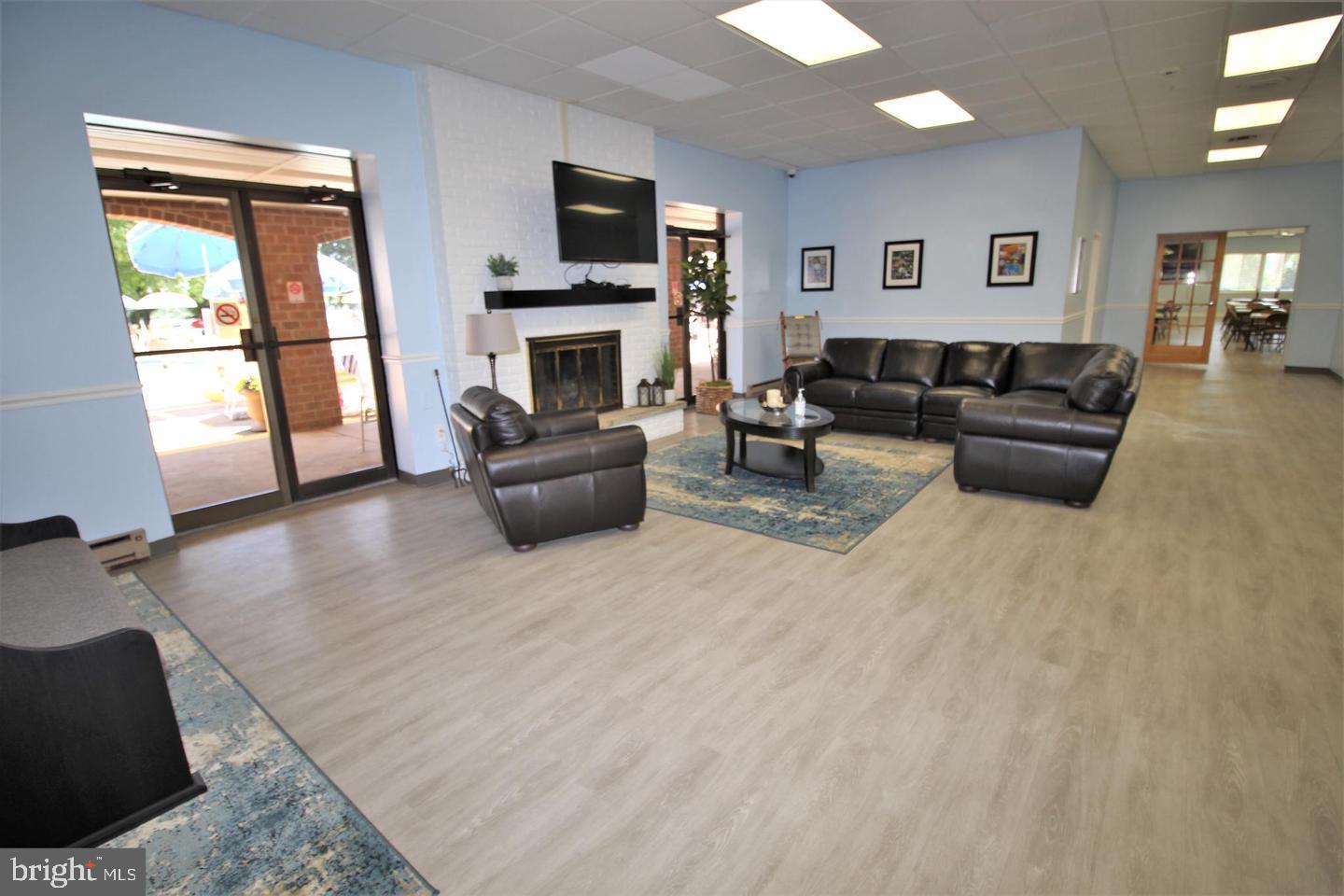 62204 Delaire Landing Road, Unit 204 Philadelphia, PA 19114 - Photo 30 of 35 a living room with furniture a flat screen tv and a fireplace