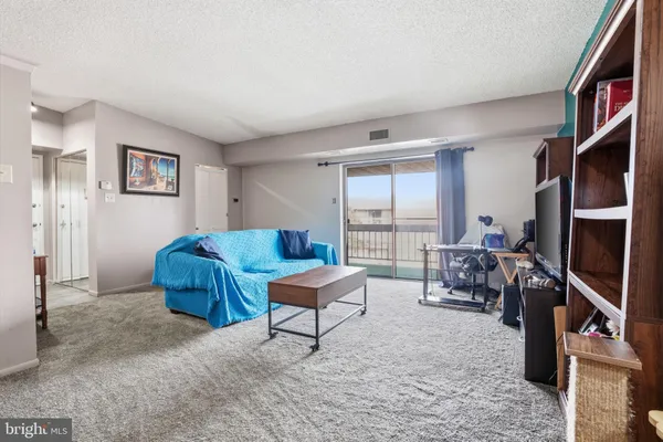 a living room with furniture a large window and a flat screen tv