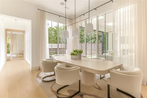 a dining room with furniture a chandelier and wooden floor