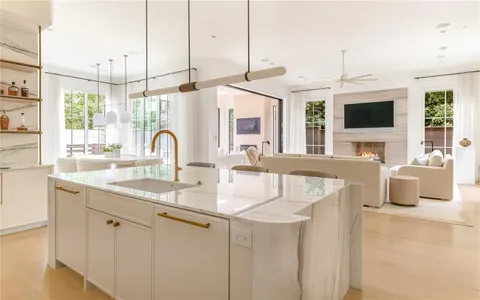 a kitchen with a sink and a wooden floor