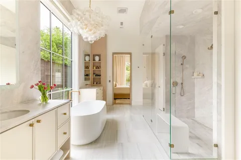a bathroom with a granite countertop sink mirror bathtub and shower