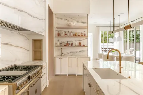 a kitchen with granite countertop a stove and a sink