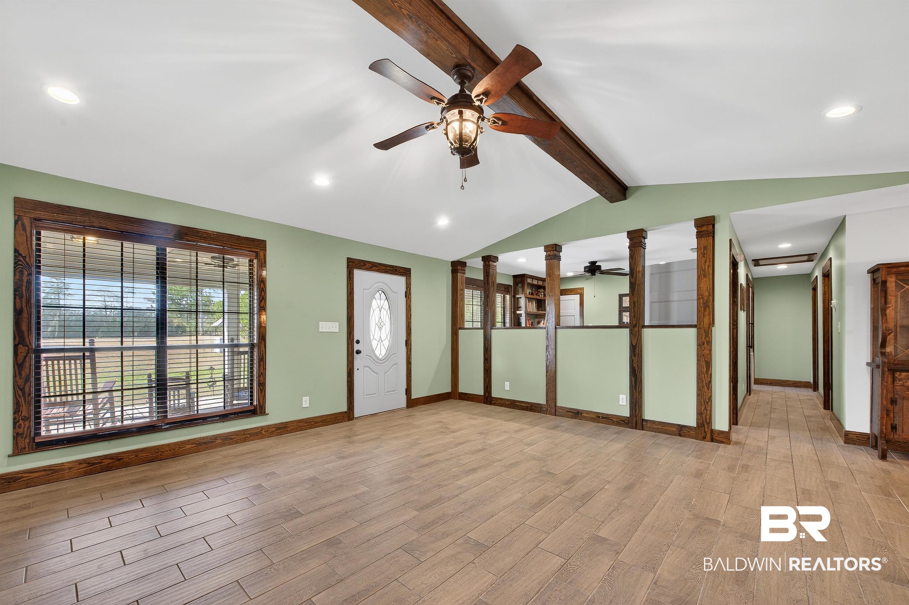 29635 Gardner Road Elberta, AL 36530 - Photo 15 of 66 Empty room featuring wood finish floors, ceiling fan, recessed lighting, and decorative columns