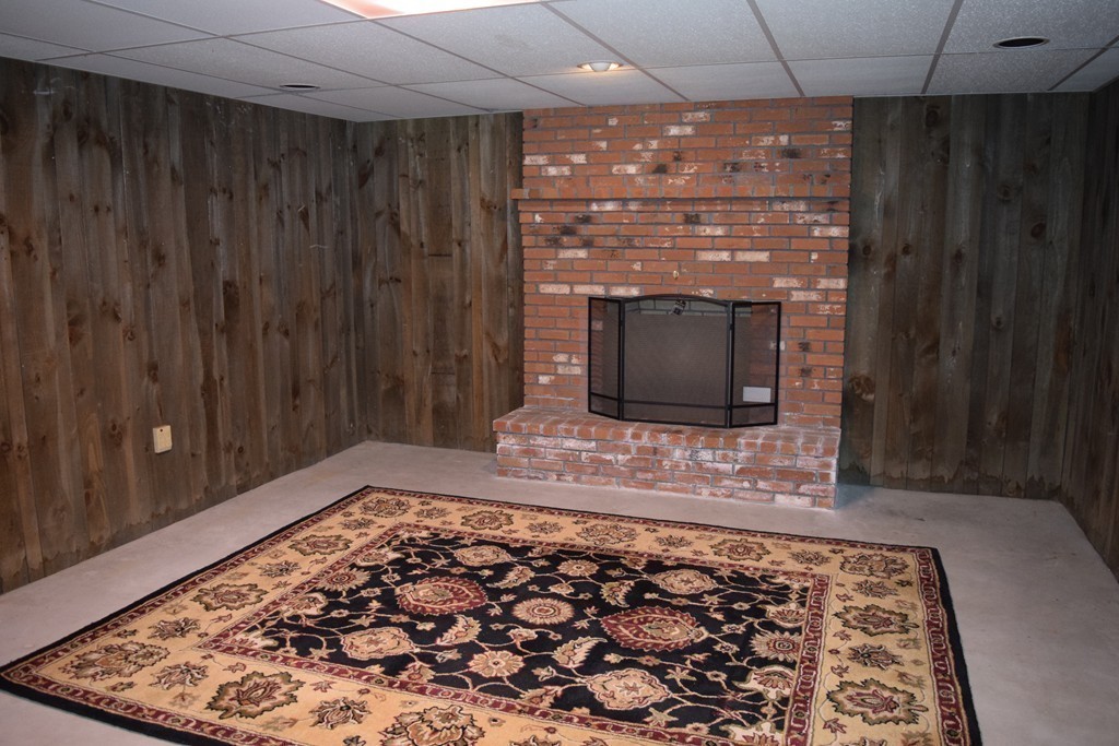 3 Bishop Road Rochester, MA 02770 - Photo 23 of 30 a living room with a rug and a fireplace