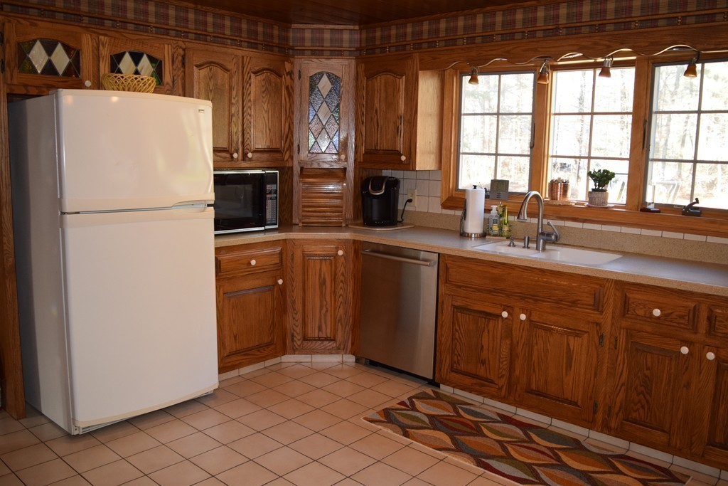 3 Bishop Road Rochester, MA 02770 - Photo 8 of 30 a kitchen with a refrigerator sink and cabinets