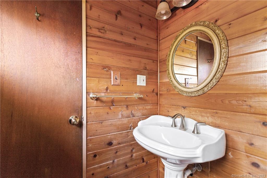 2 Walker Court Greenwich, CT 06831 - Photo 13 of 39 a bathroom with a sink a mirror and a toilet