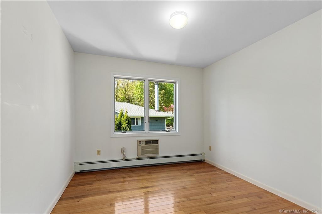 2 Walker Court Greenwich, CT 06831 - Photo 21 of 39 an empty room with wooden floor and windows