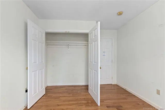 a view of hallway with wooden floor