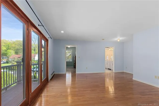 wooden floor in an empty room with a window