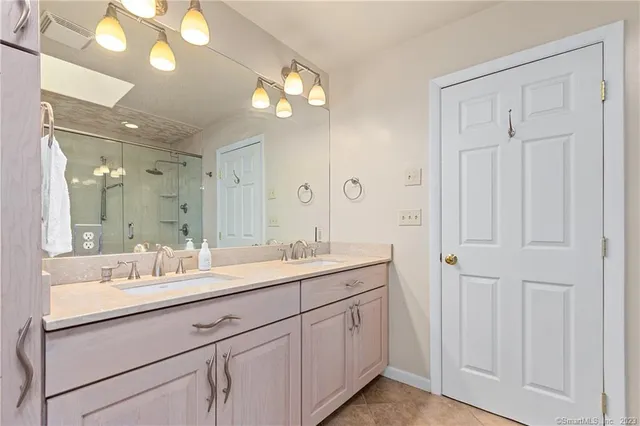 a bathroom with a sink vanity and a mirror