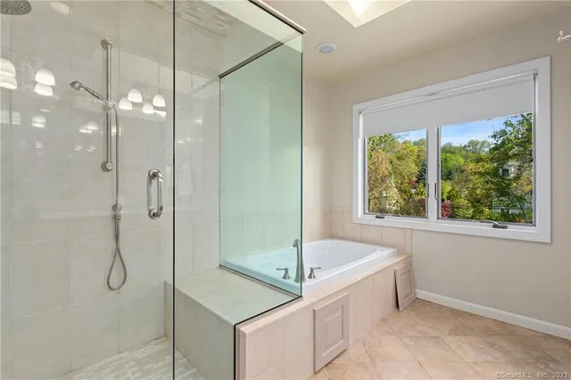 a bathroom with a tub and a shower