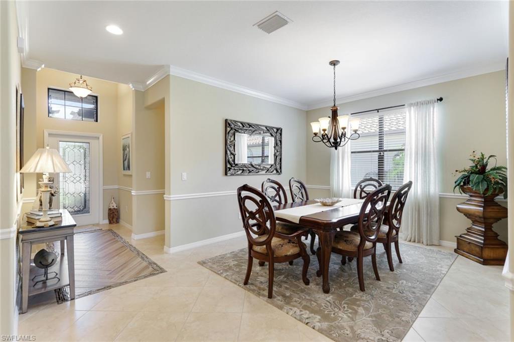 3917 Sapphire Way Naples, FL 34114 - Photo 12 of 44 a view of a dining room with furniture window and wooden floor