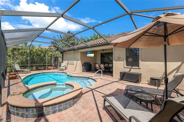 a view of a patio with swimming pool table and chairs