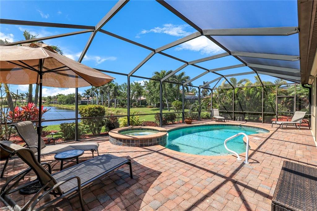 3917 Sapphire Way Naples, FL 34114 - Photo 27 of 44 a view of a patio with a table and chairs under an umbrella