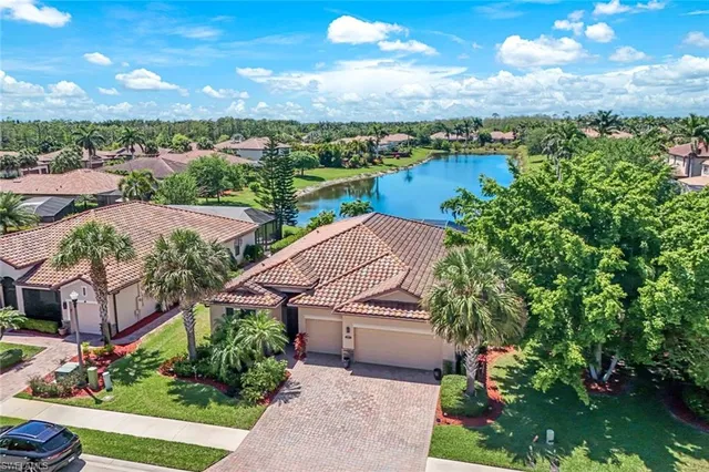 a aerial view of a house with a garden and lake view