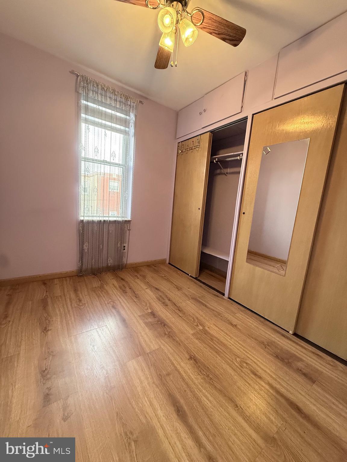 3146 Mercer Street Philadelphia, PA 19134 - Photo 11 of 22 an empty room with wooden floor and windows
