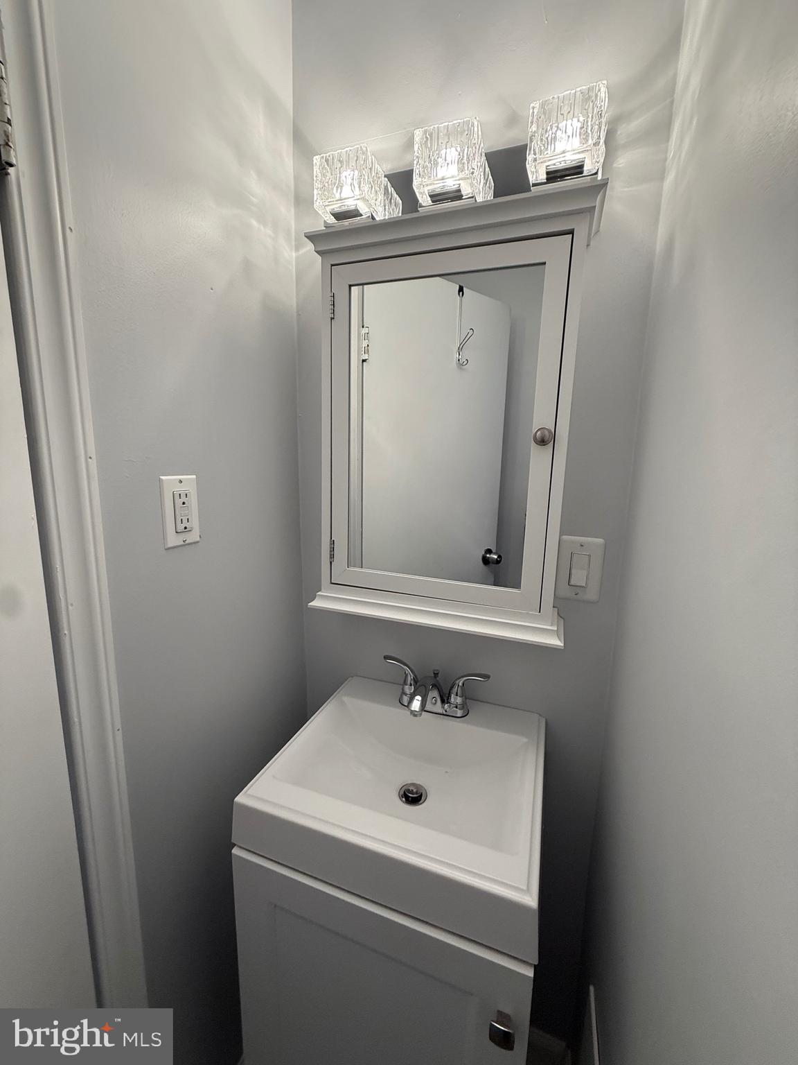 3146 Mercer Street Philadelphia, PA 19134 - Photo 12 of 22 a bathroom with a sink and a mirror