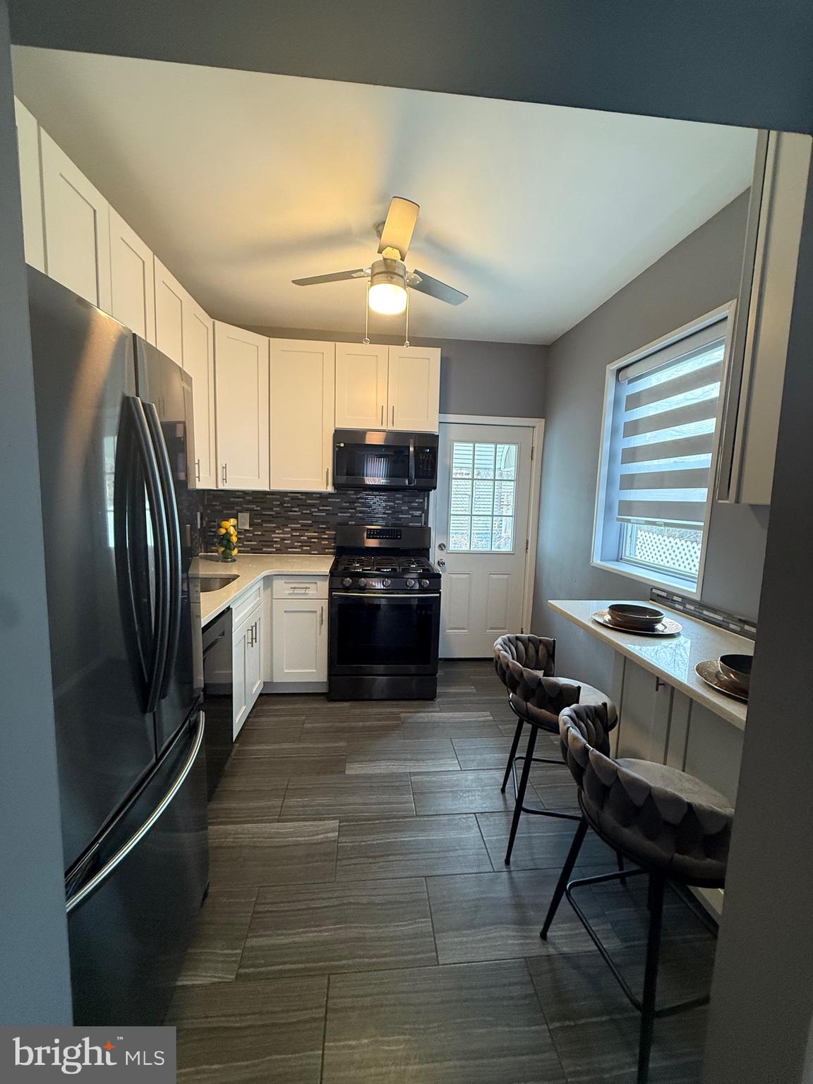 3146 Mercer Street Philadelphia, PA 19134 - Photo 19 of 22 a kitchen with stainless steel appliances a refrigerator a stove a sink dishwasher and a refrigerator