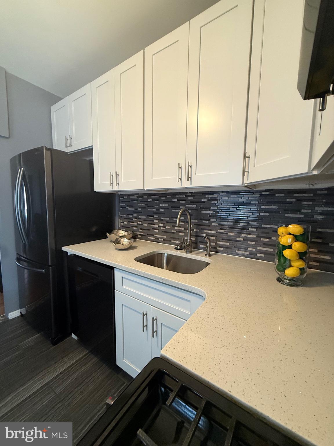 3146 Mercer Street Philadelphia, PA 19134 - Photo 21 of 22 a kitchen with stainless steel appliances a sink dishwasher stove and refrigerator