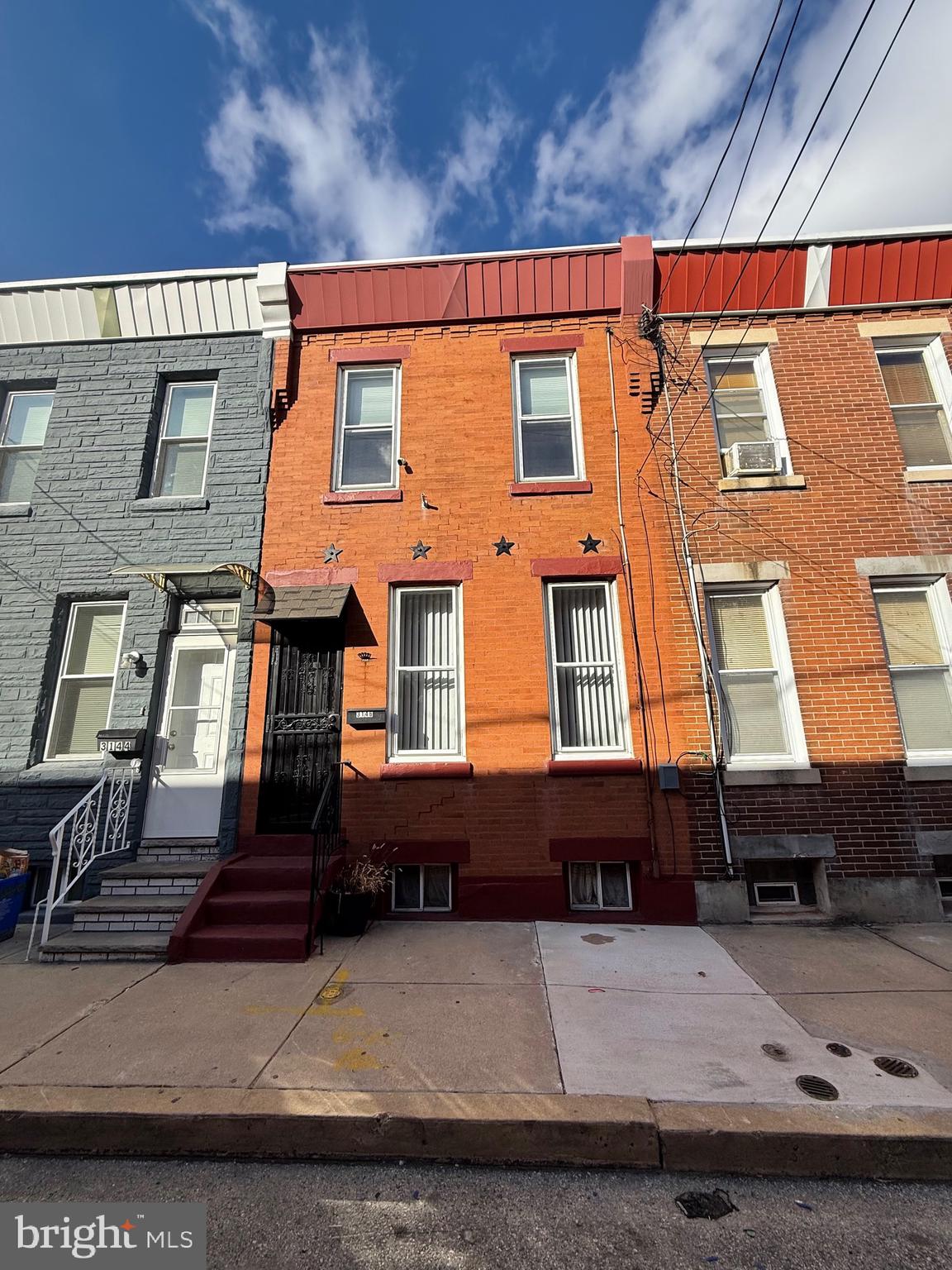 3146 Mercer Street Philadelphia, PA 19134 - Photo 3 of 22 a front view of a residential apartment building with a yard