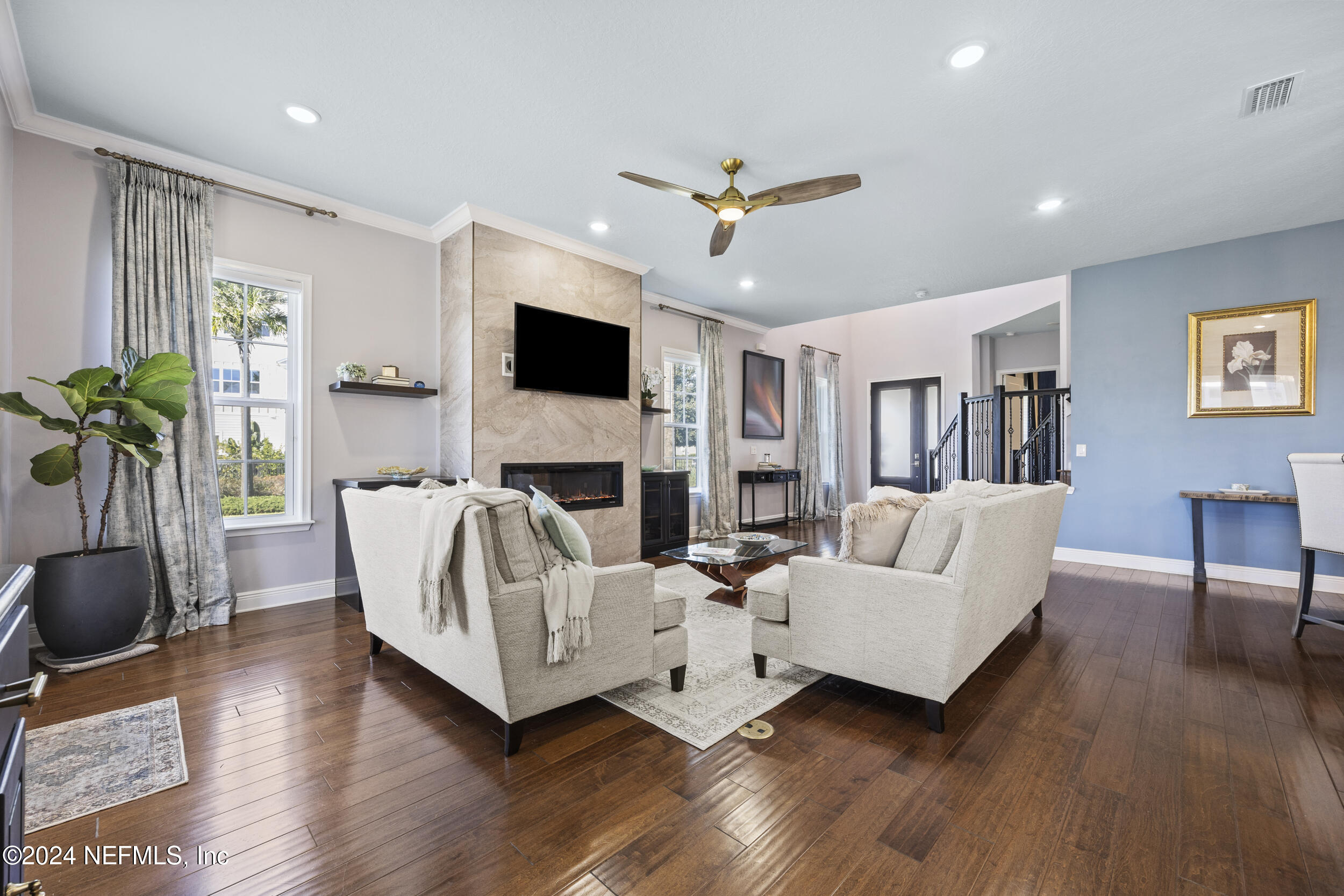 228 Rum Runner Way St. Johns, FL 32259 - Photo 11 of 97 a living room with furniture fireplace and a flat screen tv