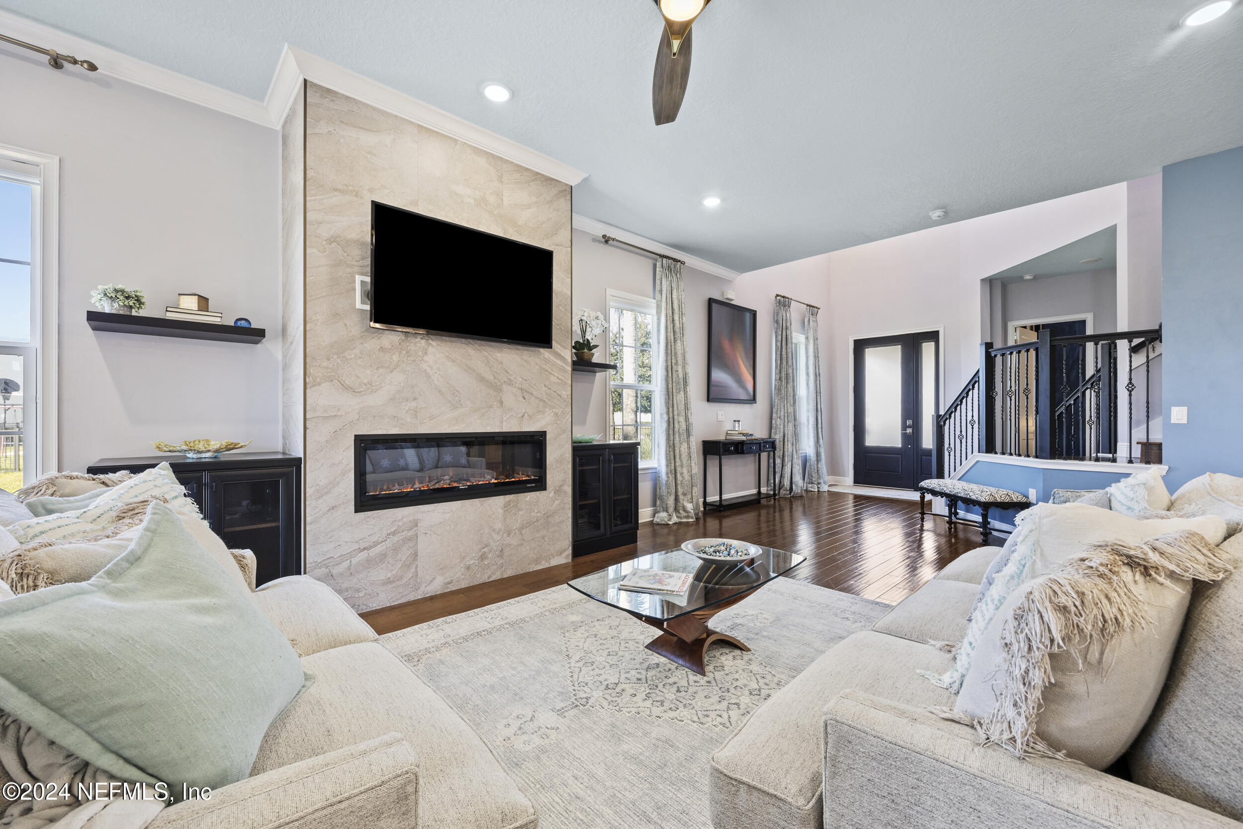 228 Rum Runner Way St. Johns, FL 32259 - Photo 12 of 97 a living room with furniture flat screen tv and a fireplace