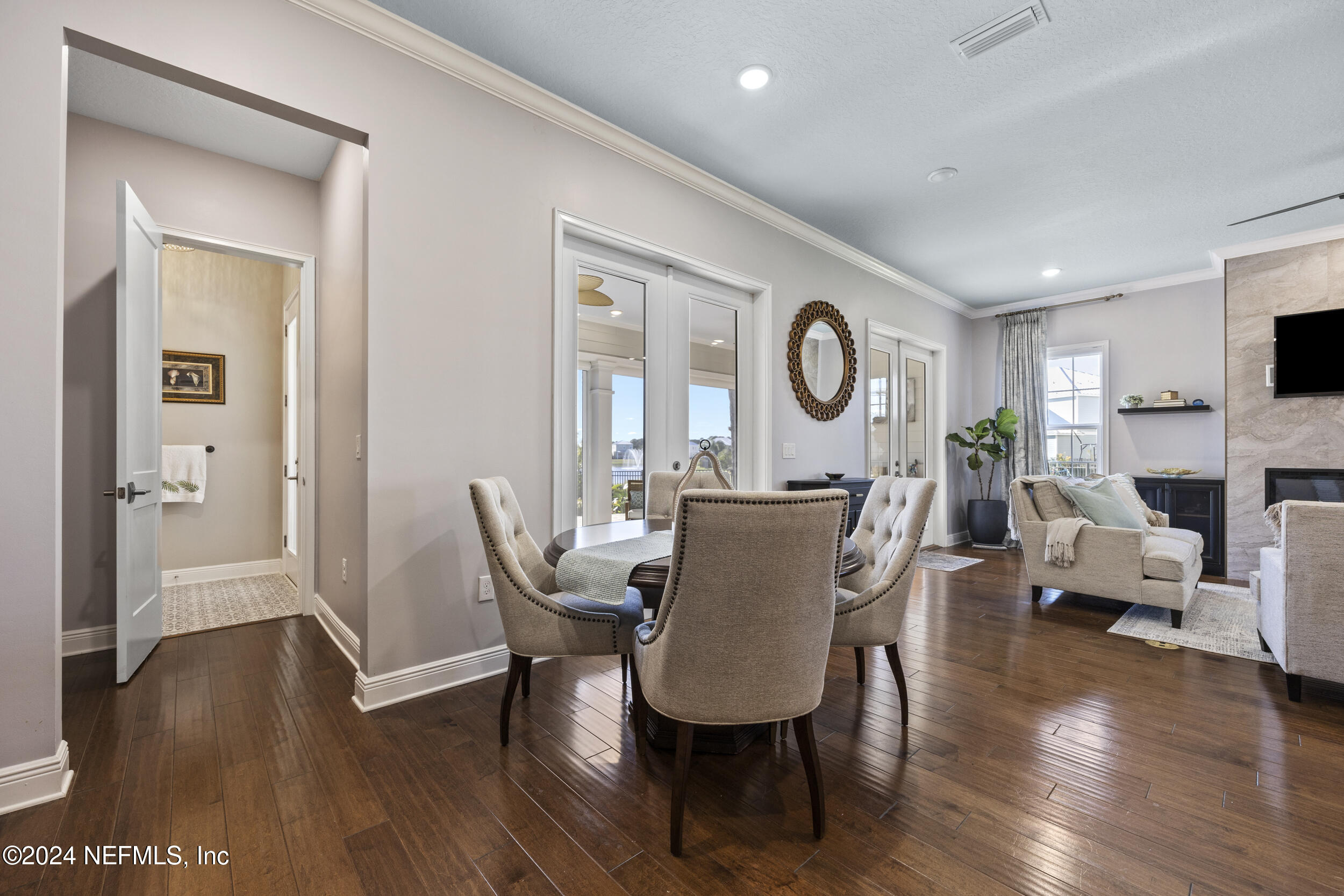 228 Rum Runner Way St. Johns, FL 32259 - Photo 16 of 97 a view of a dining room with furniture wooden floor and a chandelier