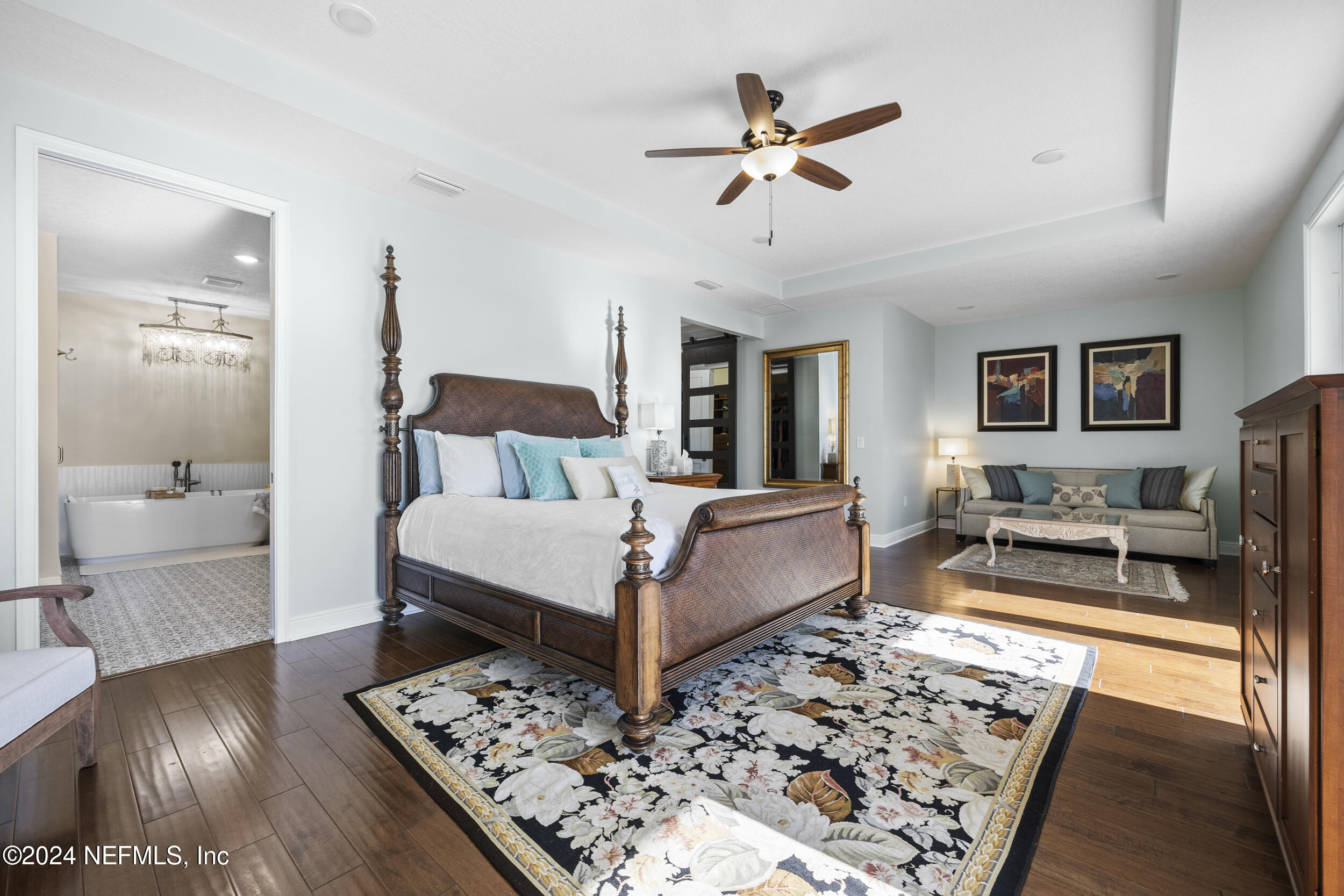 228 Rum Runner Way St. Johns, FL 32259 - Photo 37 of 97 a bedroom with a bed a couch and wooden floor