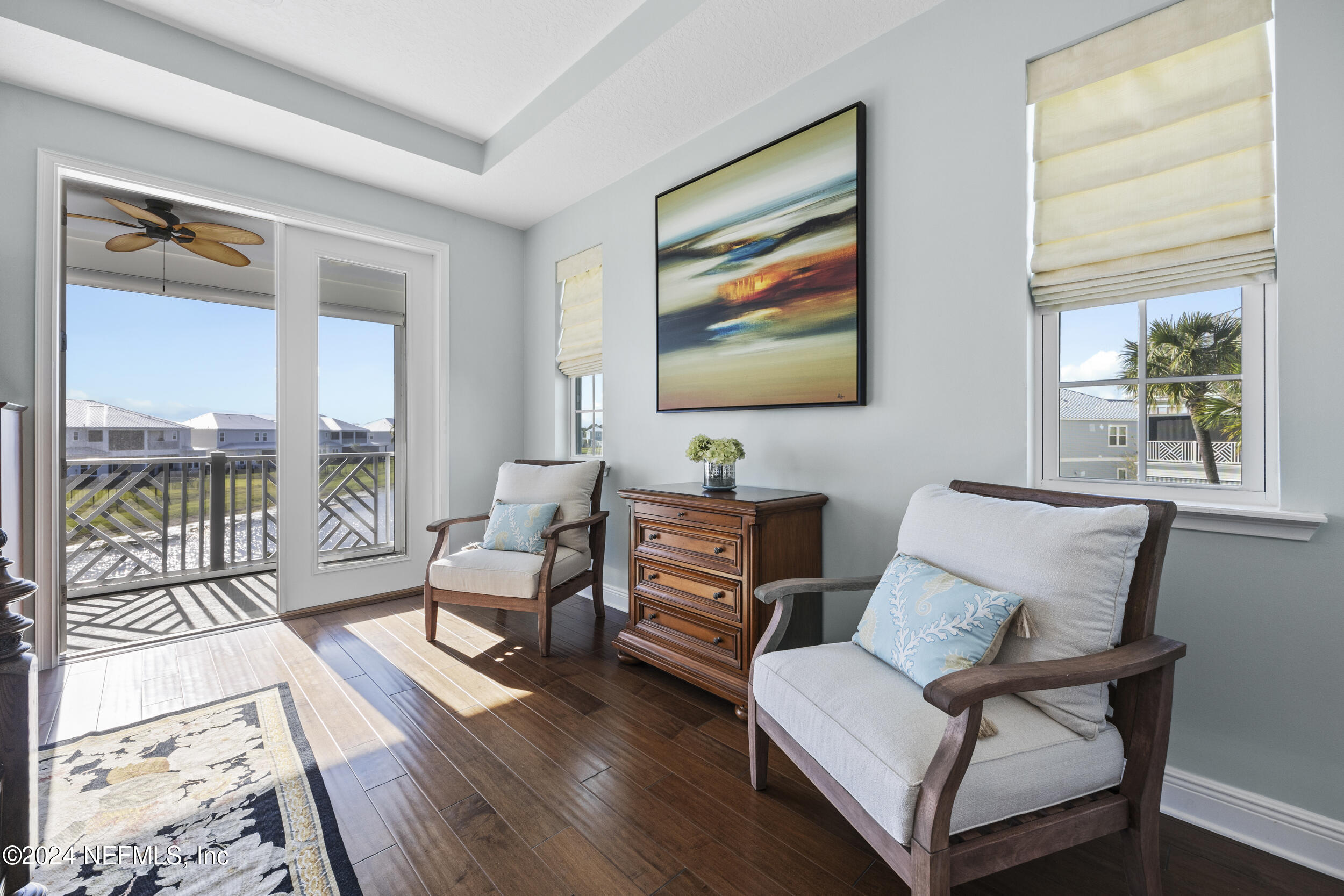 228 Rum Runner Way St. Johns, FL 32259 - Photo 39 of 97 a living room with furniture a flat screen tv and a floor to ceiling window