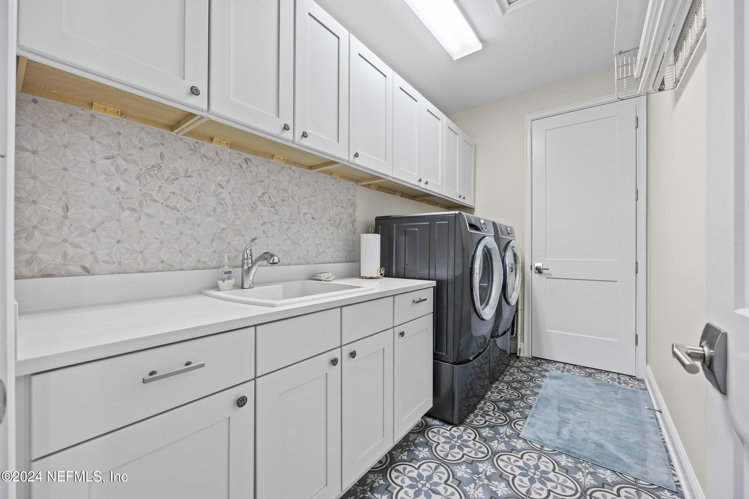 228 Rum Runner Way St. Johns, FL 32259 - Photo 54 of 97 a utility room with sink dryer and washer