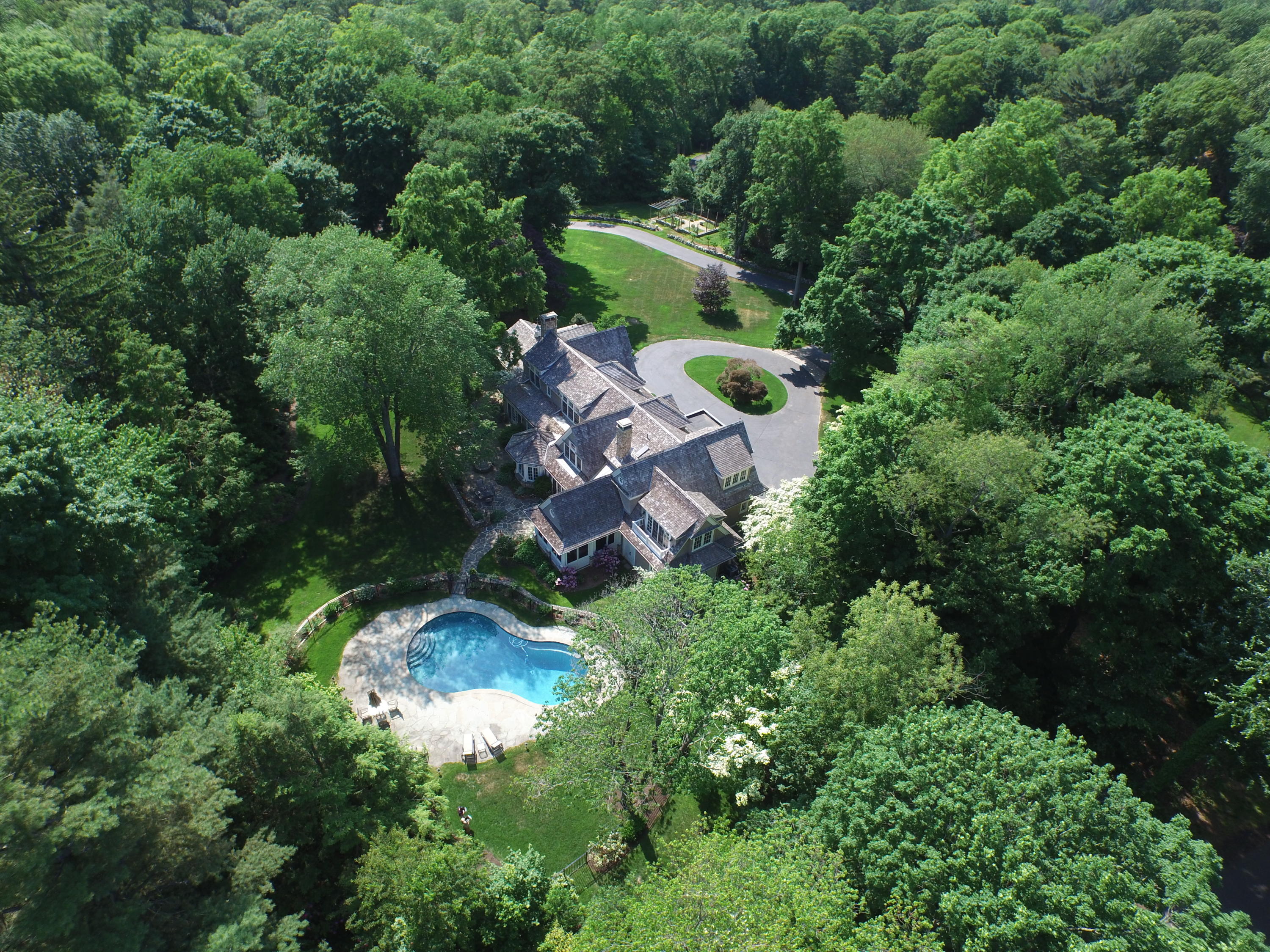72 Ridge Acres Road Darien, CT 06820 - Photo 1 of 25 an aerial view of a house with a yard and greenery