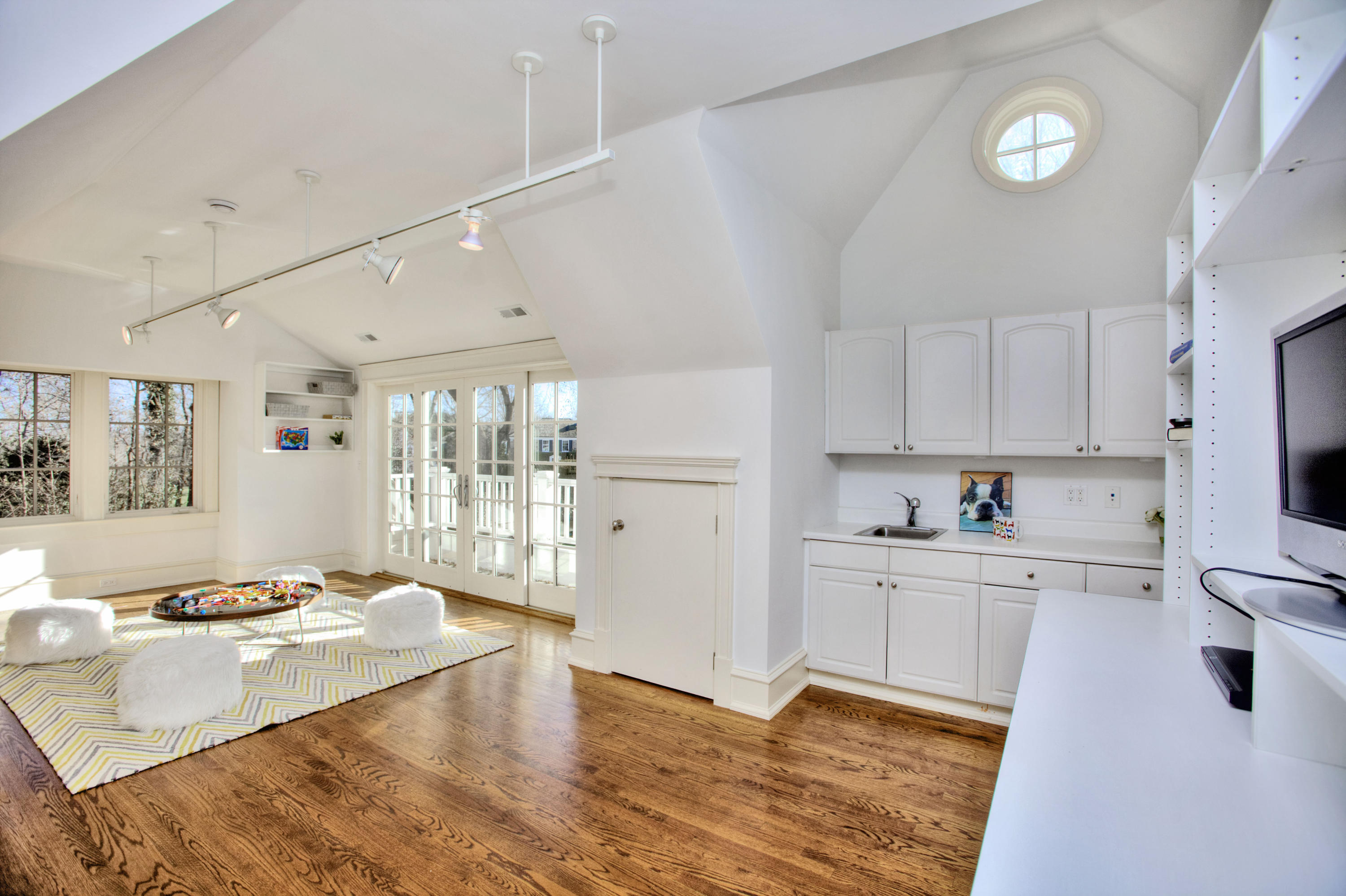72 Ridge Acres Road Darien, CT 06820 - Photo 19 of 25 a large kitchen with a refrigerator a sink dishwasher a stove and white cabinets with wooden floor