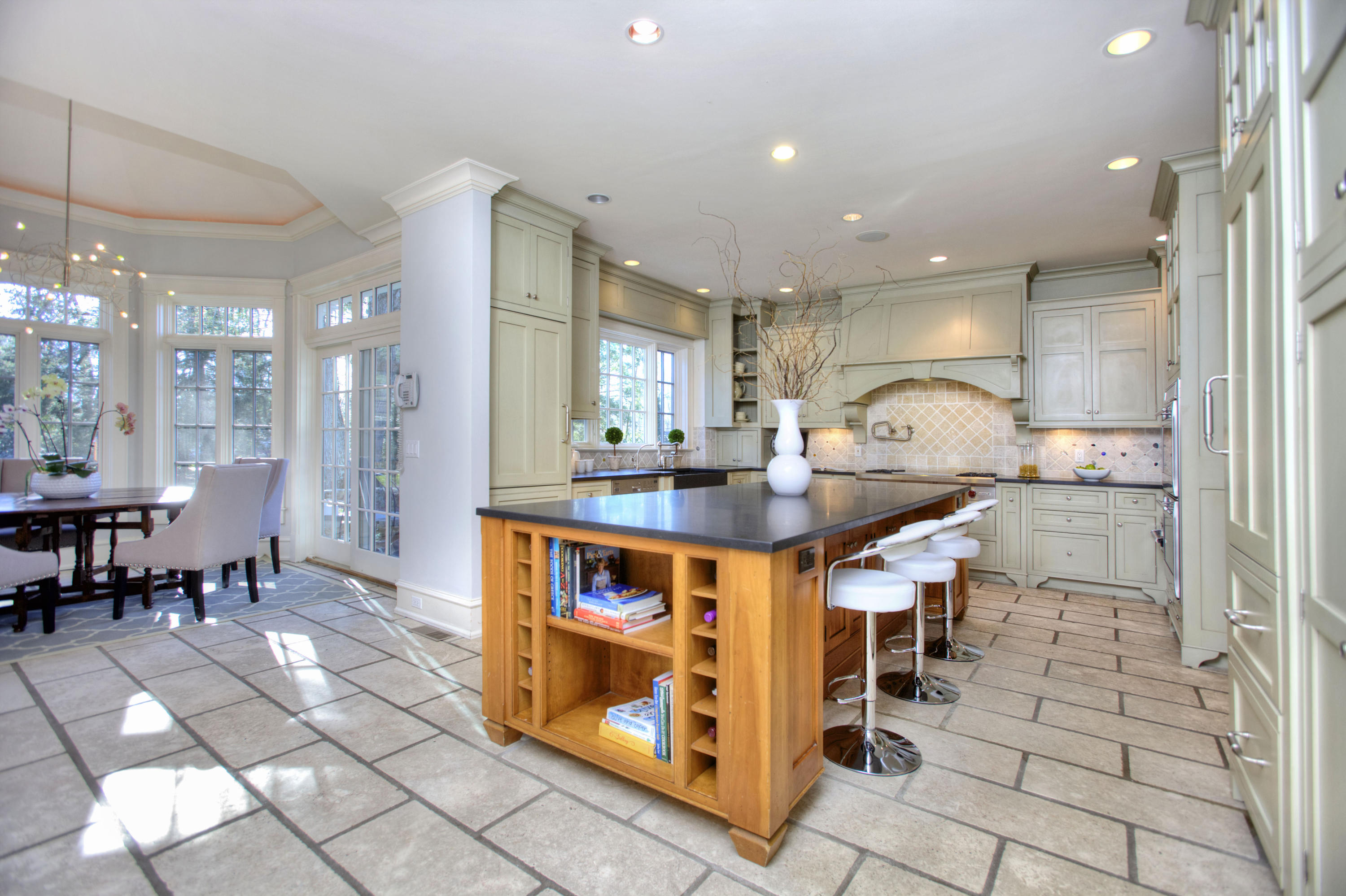 72 Ridge Acres Road Darien, CT 06820 - Photo 7 of 25 a kitchen with stainless steel appliances kitchen island granite countertop a table and chairs in it