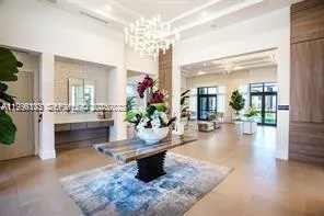 a lobby with furniture and a chandelier